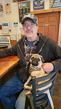 My newest pup, Ralphie with me at the pub my partner and I own. 