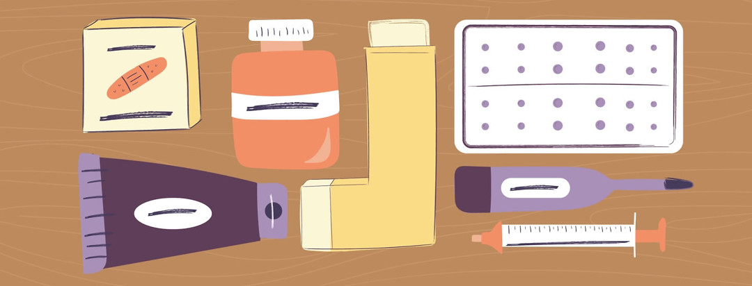 Medications including a pill bottle, an inhaler, bandaids, and a thermometer arranged on a table