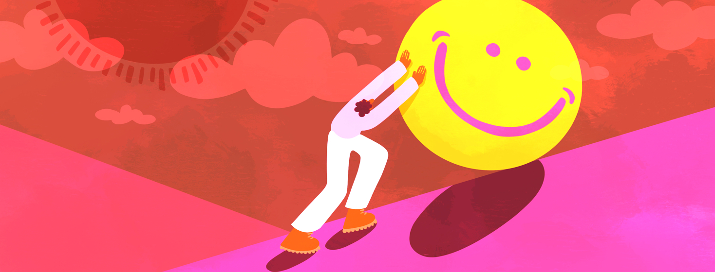 A man rolling a large boulder with a happy face on it up a steep hill.