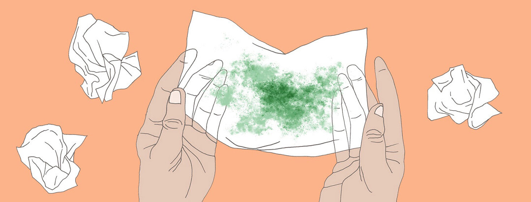 two hands hold up a tissue with mucus