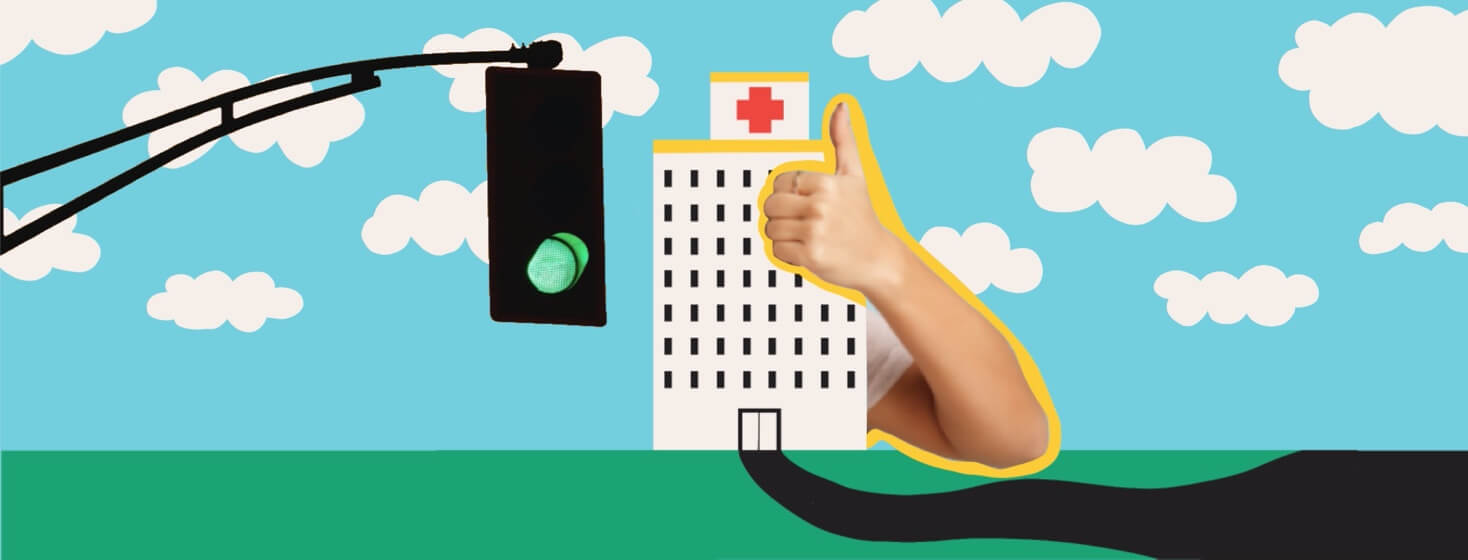 A thumbs up comes from around a hospital, and a green traffic light hangs over it.