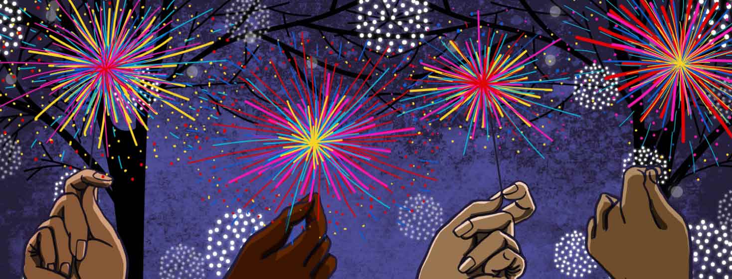 four hands holding sparklers fireworks in front of a background of a night sky with trees full of holiday lights.